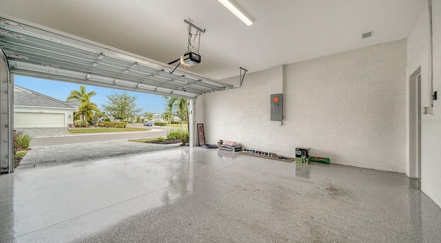 garage featuring electric panel and a garage door opener