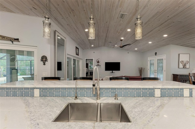 kitchen with wood ceiling, sink, french doors, pendant lighting, and vaulted ceiling