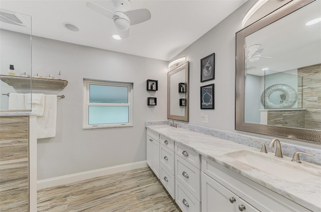 bathroom with ceiling fan, a shower, wood-type flooring, and vanity