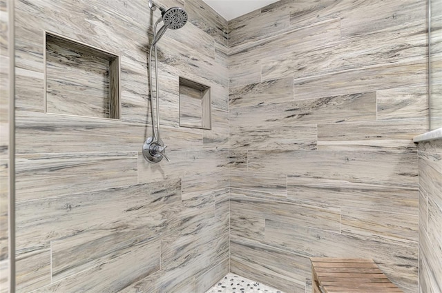 bathroom with tiled shower