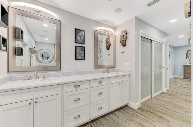 bathroom featuring hardwood / wood-style floors and vanity