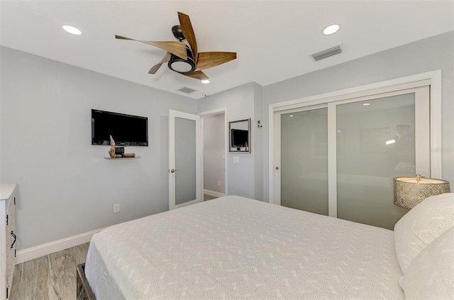 bedroom with hardwood / wood-style floors, a closet, and ceiling fan