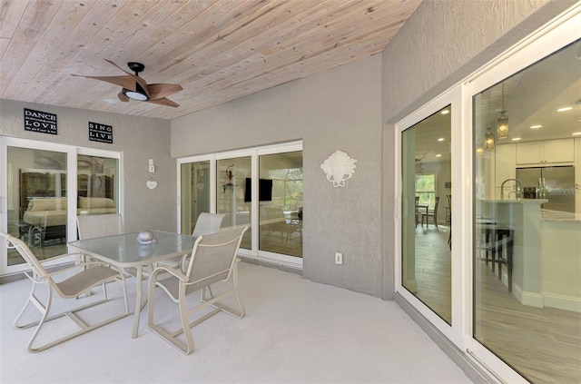 sunroom / solarium featuring wood ceiling, ceiling fan, and sink