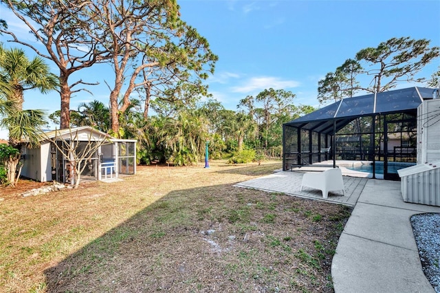 view of yard featuring glass enclosure and a patio area