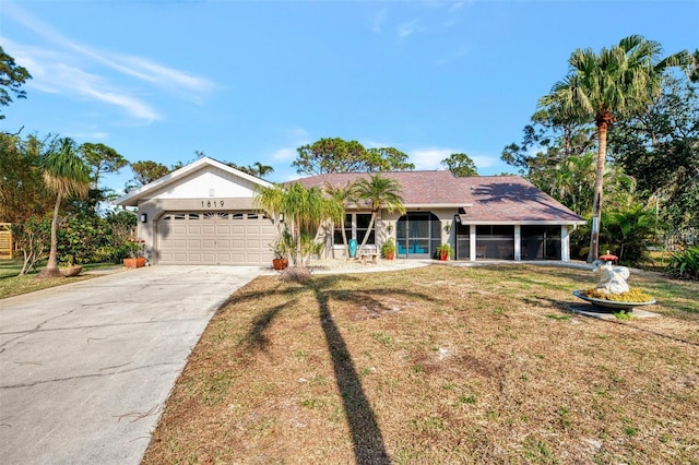 single story home featuring a front yard and a sunroom