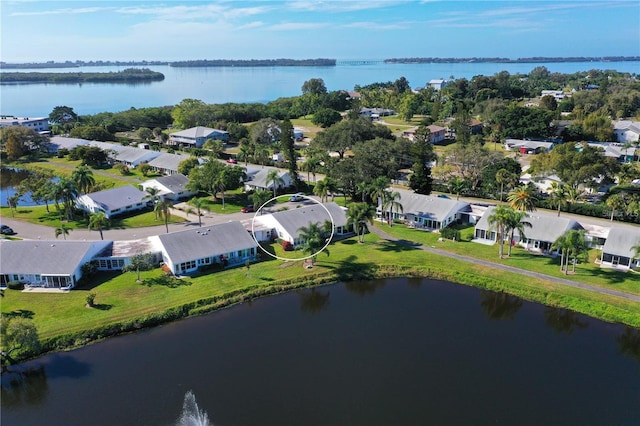 drone / aerial view featuring a residential view and a water view