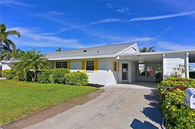 ranch-style house with a carport and a front yard