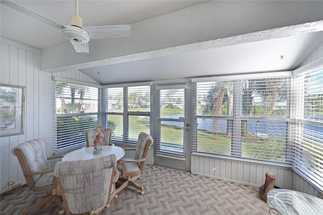 sunroom / solarium featuring ceiling fan and lofted ceiling