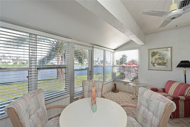 sunroom with a wealth of natural light, ceiling fan, a water view, and lofted ceiling