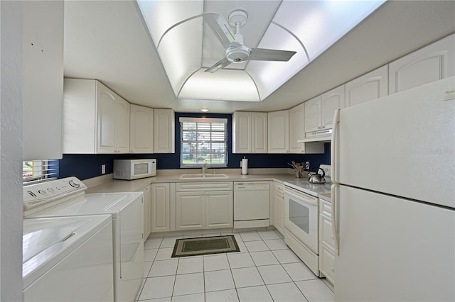 kitchen with white appliances, sink, washing machine and clothes dryer, white cabinets, and light tile patterned flooring