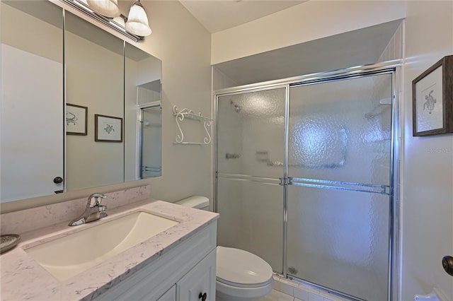 bathroom with vanity, an enclosed shower, and toilet