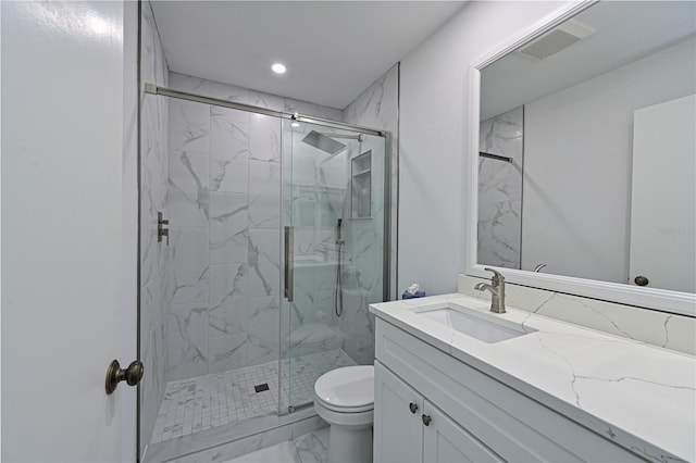 bathroom with toilet, an enclosed shower, and vanity