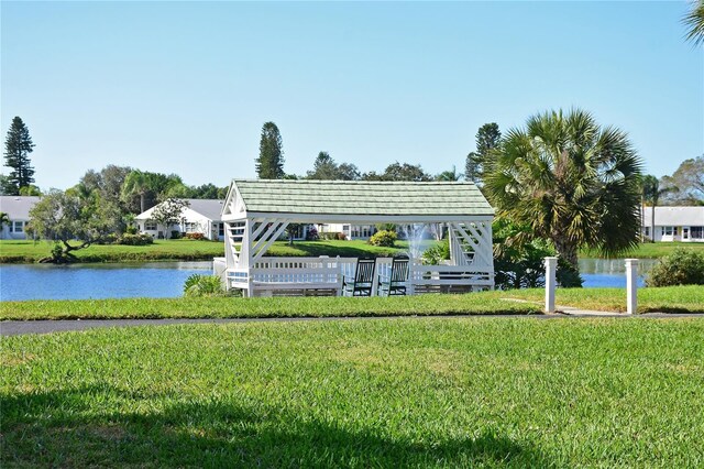 view of home's community featuring a water view and a lawn