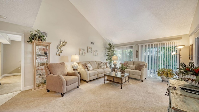 carpeted living room featuring high vaulted ceiling