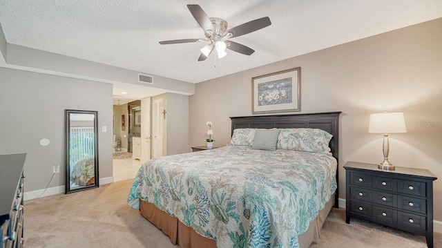 carpeted bedroom featuring ensuite bathroom, ceiling fan, a textured ceiling, and a closet