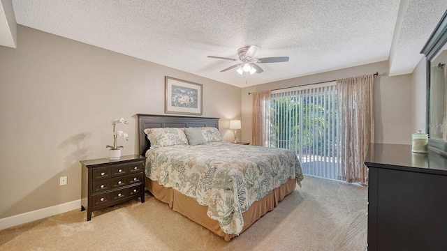 carpeted bedroom with access to exterior, a textured ceiling, and ceiling fan