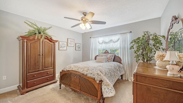 carpeted bedroom with ceiling fan and a textured ceiling