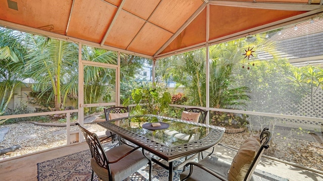 sunroom featuring plenty of natural light and vaulted ceiling