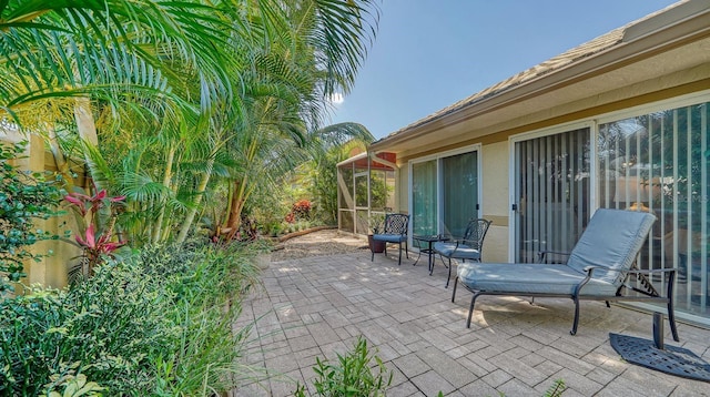 view of patio / terrace featuring a sunroom