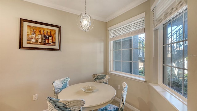 dining room with baseboards and ornamental molding