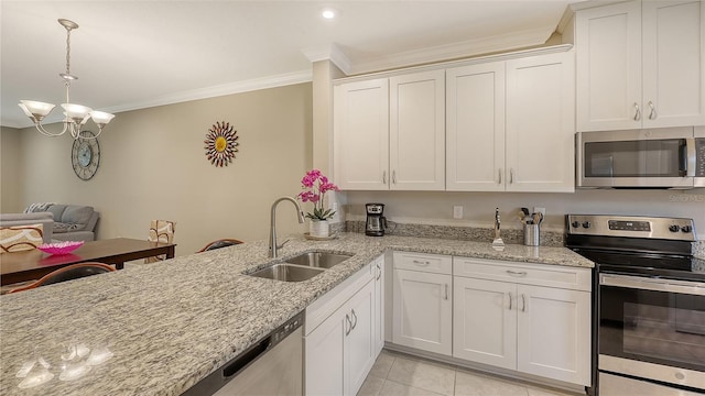 kitchen with light tile patterned floors, ornamental molding, stainless steel appliances, white cabinetry, and a sink