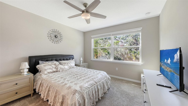 carpeted bedroom with a ceiling fan and baseboards