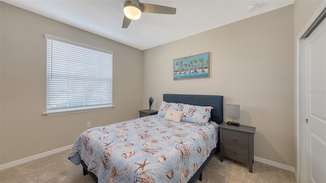 carpeted bedroom featuring ceiling fan and baseboards