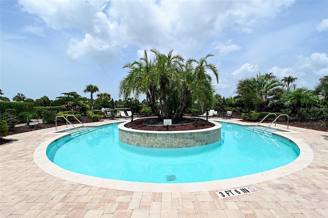 view of swimming pool featuring a patio area