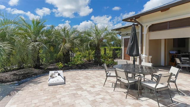 view of patio / terrace featuring outdoor dining space and fence