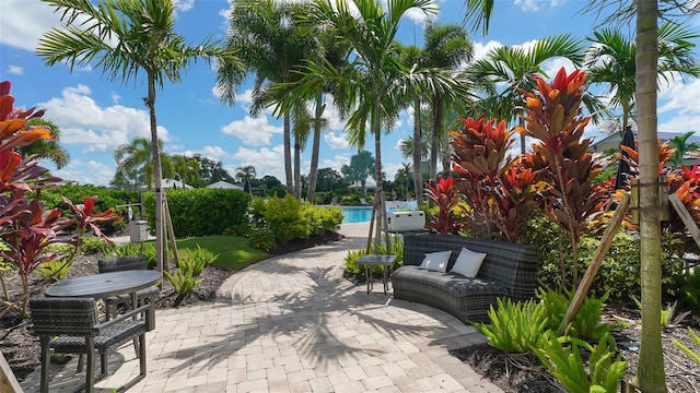 view of property's community featuring a pool and a patio