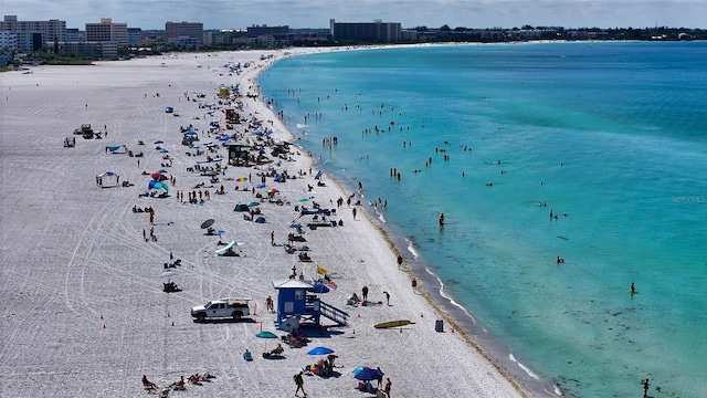 bird's eye view with a water view, a view of city, and a beach view