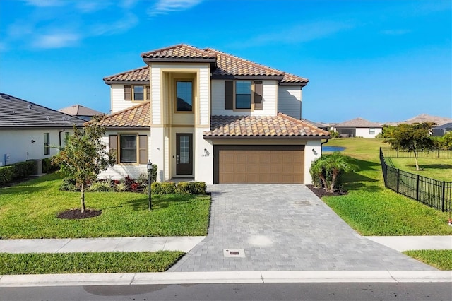 mediterranean / spanish-style home featuring a garage and a front yard