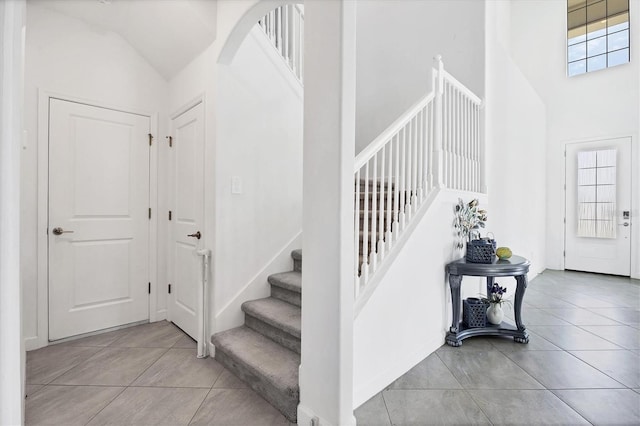 tiled entrance foyer featuring lofted ceiling