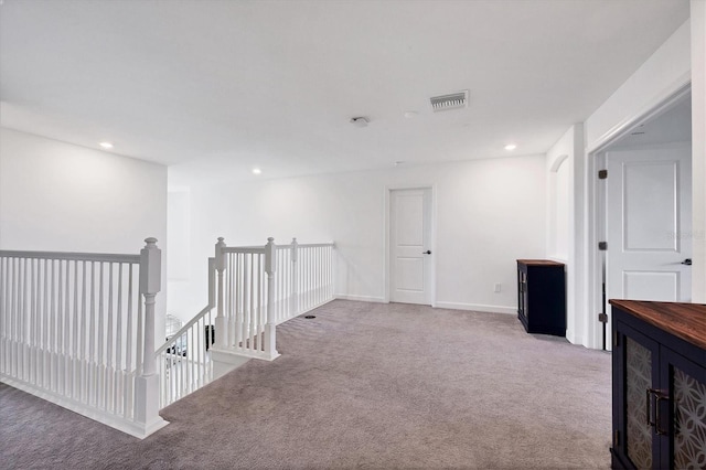 hallway featuring light carpet