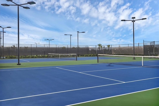 view of tennis court with basketball hoop