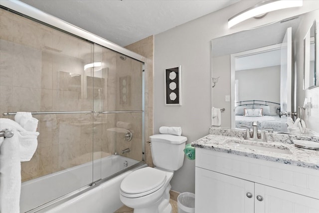 full bathroom featuring toilet, enclosed tub / shower combo, and vanity