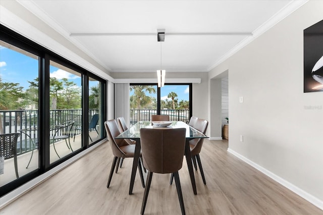 dining space featuring crown molding and light hardwood / wood-style floors