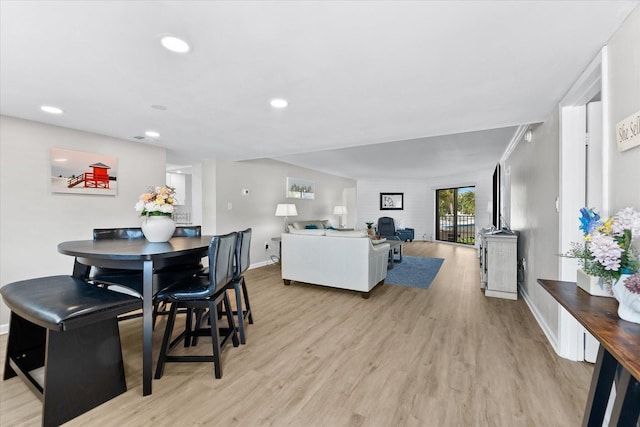 dining room featuring ornamental molding and light hardwood / wood-style floors