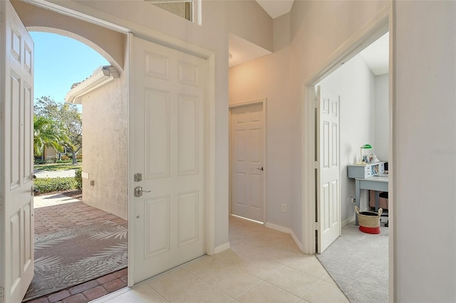 foyer entrance featuring light colored carpet