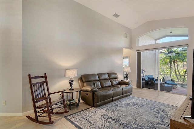 tiled living room featuring vaulted ceiling