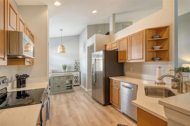 kitchen with pendant lighting, stainless steel appliances, light hardwood / wood-style floors, and sink