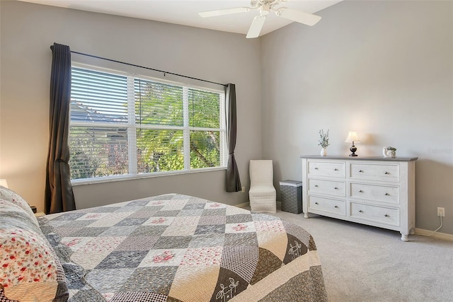 carpeted bedroom with multiple windows and ceiling fan