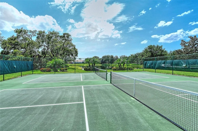 view of tennis court featuring basketball hoop