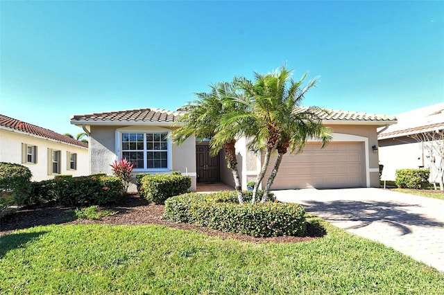 mediterranean / spanish-style home with a front lawn and a garage