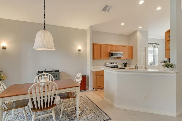 kitchen with kitchen peninsula, appliances with stainless steel finishes, light tile patterned floors, and hanging light fixtures