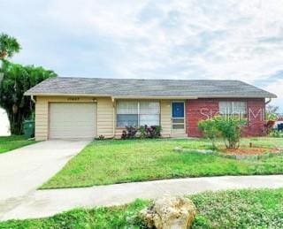 single story home with a garage and a front lawn