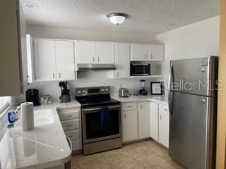 kitchen featuring white cabinets and stainless steel appliances