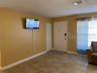 entryway with a textured ceiling