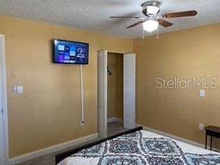 unfurnished bedroom featuring a textured ceiling, a closet, and ceiling fan