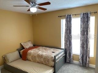 carpeted bedroom with ceiling fan